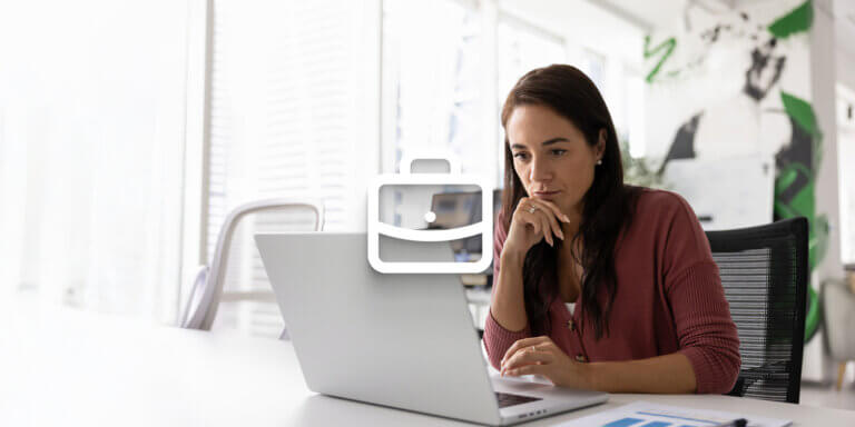 An image showing a woman looking at a laptop screen while at the office and a white briefcase icon in the centre.