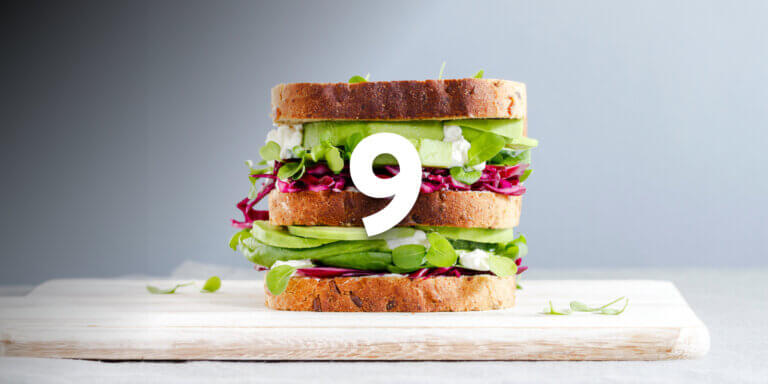 An image showing a tall sandwich in a grey background featuring the number 9.