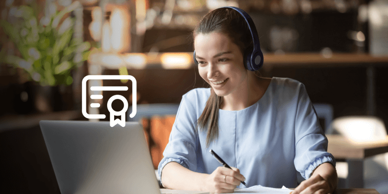 A woman looking at a laptop screen and smiling.